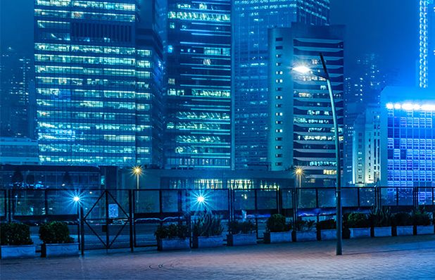 An image of a cityscape at night, illuminated in shades of blue. The cityscape represents a smart city powered by 5G technology, showcasing the integration of advanced connectivity and intelligent infrastructure to enhance urban living and services.