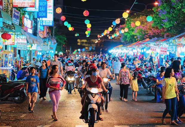 An image of a busy street in Asia with motorcycles zooming by. The street is filled with vibrant energy and movement, capturing the hustle and bustle of urban life in the region.