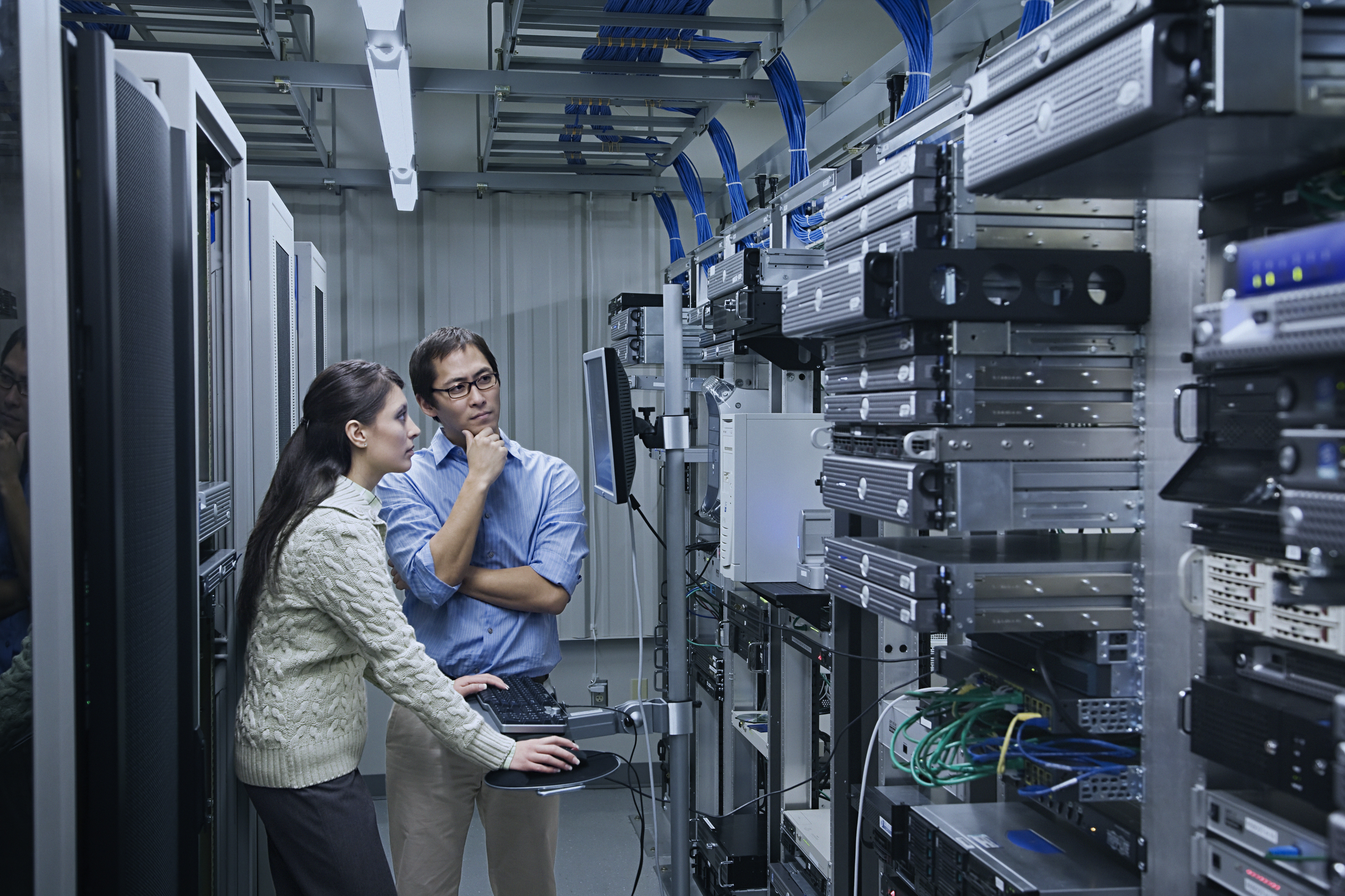 Two people in a lab working and looking at a computer screen