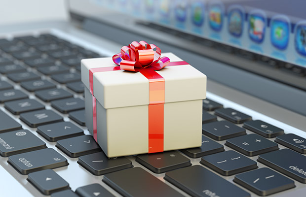 An image depicting a gift placed on top of a laptop keyboard, representing the topic of a podcast episode related to the retail industry. The gift symbolizes the concept of customer experience, online shopping, or the evolving landscape of retail in the digital era