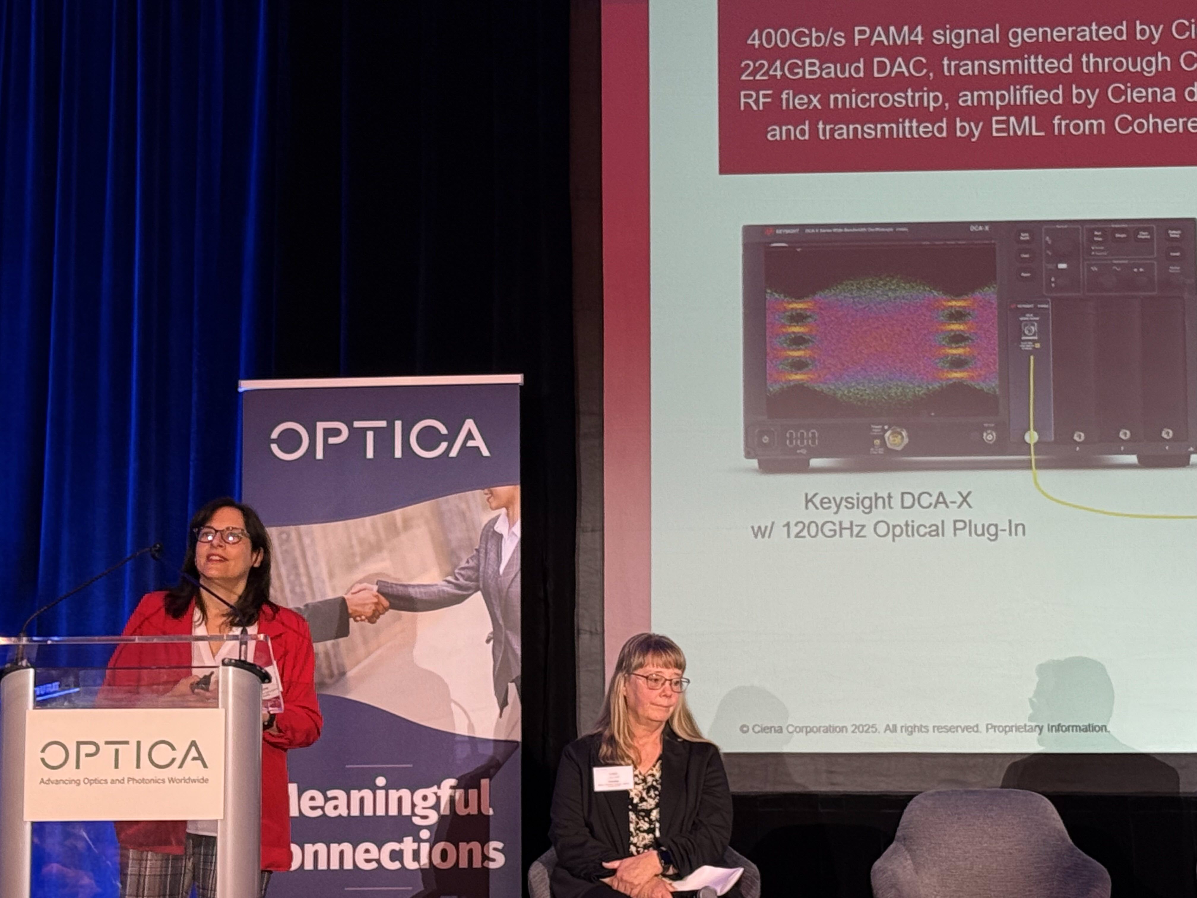 Helen Xenos behind a podium at OFC