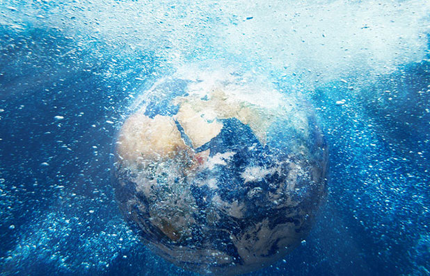 An image of a globe submerged underwater, representing the interconnectedness of global communications. The globe is partially visible, surrounded by blue water, symbolizing the role of submarine networks in facilitating international connectivity and data transmission.