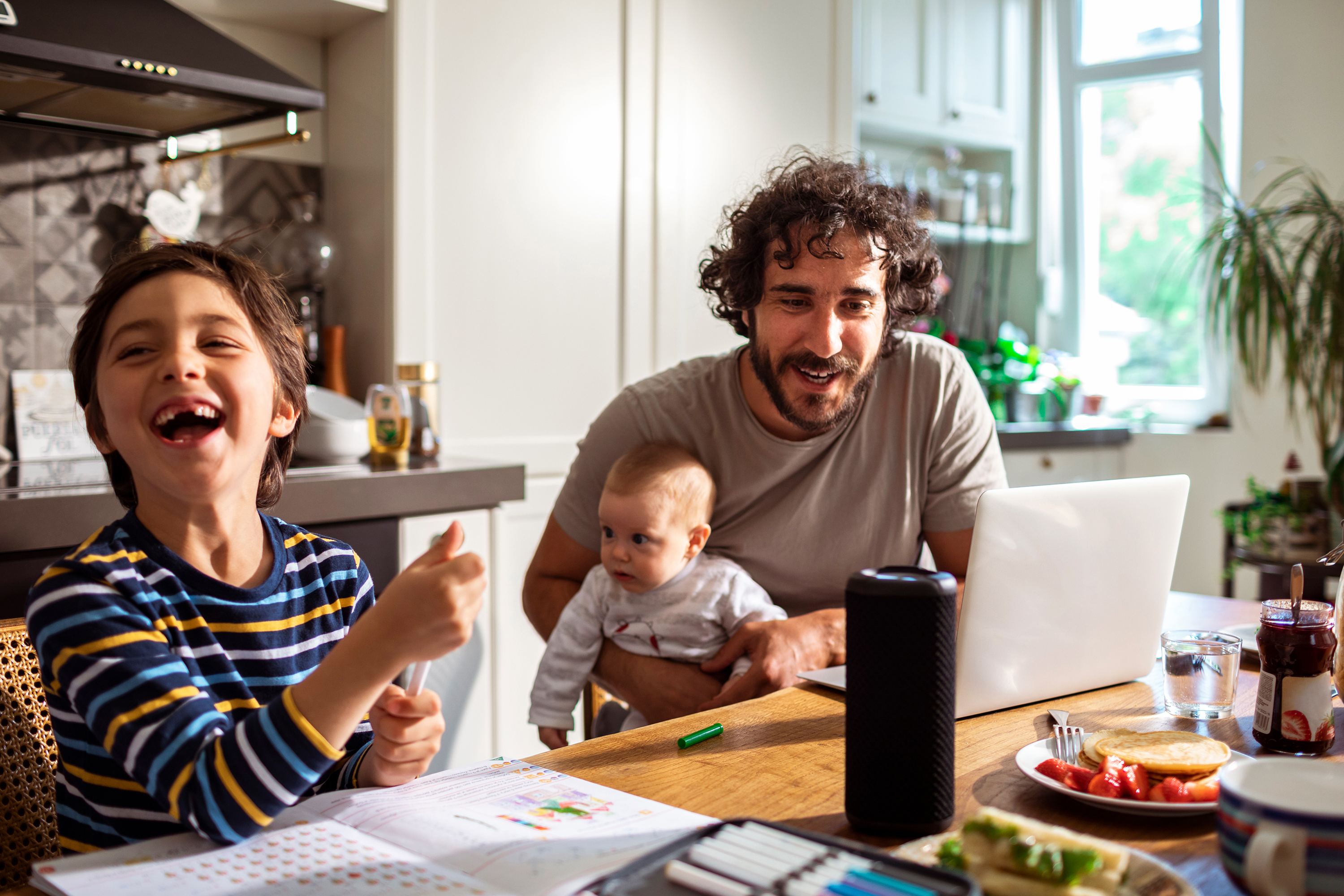 Family laughing at dinner table