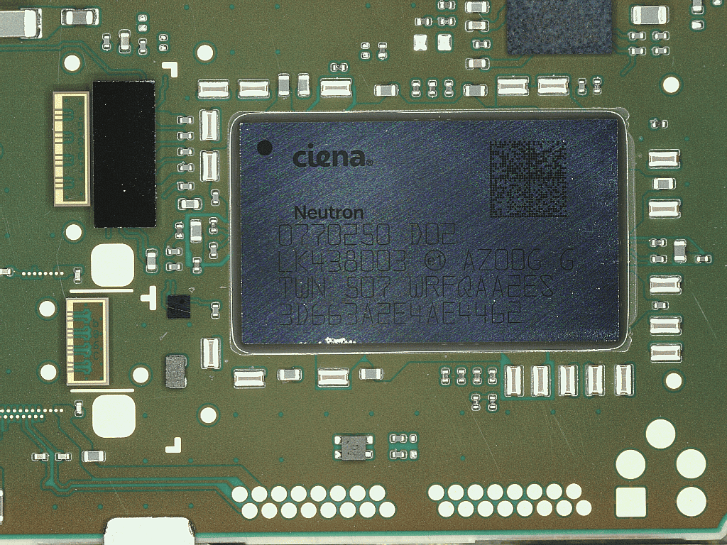 Close-up of a circuit board featuring a Ciena Neutron chip surrounded by electronic components.