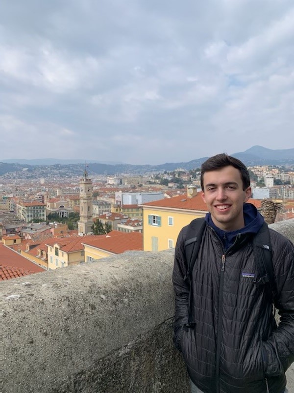 Boy smiling in front of city