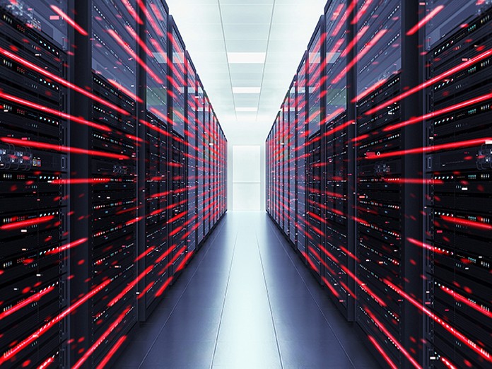 Data center with rows of black server racks aligned on either side of a central aisle