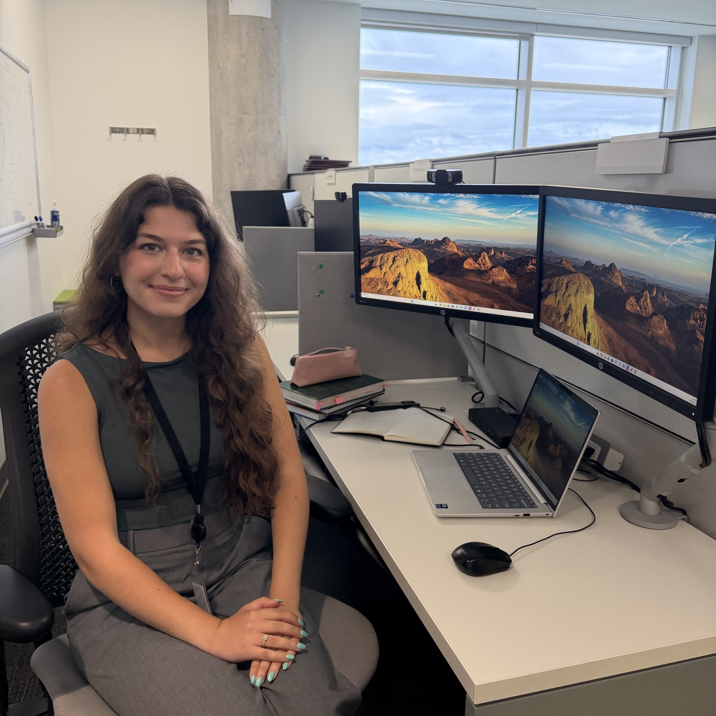 Nil sitting at her desk 