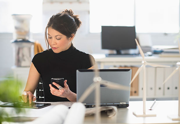 An image featuring a woman using multiple devices, representing the concept of digital resiliency. It symbolizes the ability to adapt and thrive in the digital age through the use of various technologies.