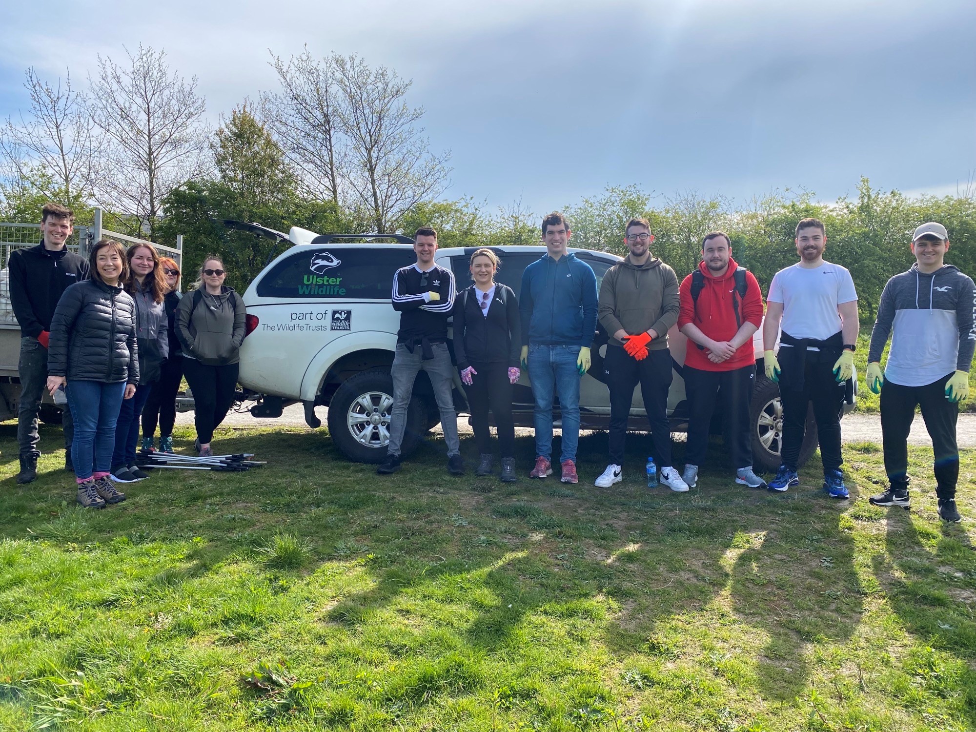 a group of people in front of a ulster wildlife van