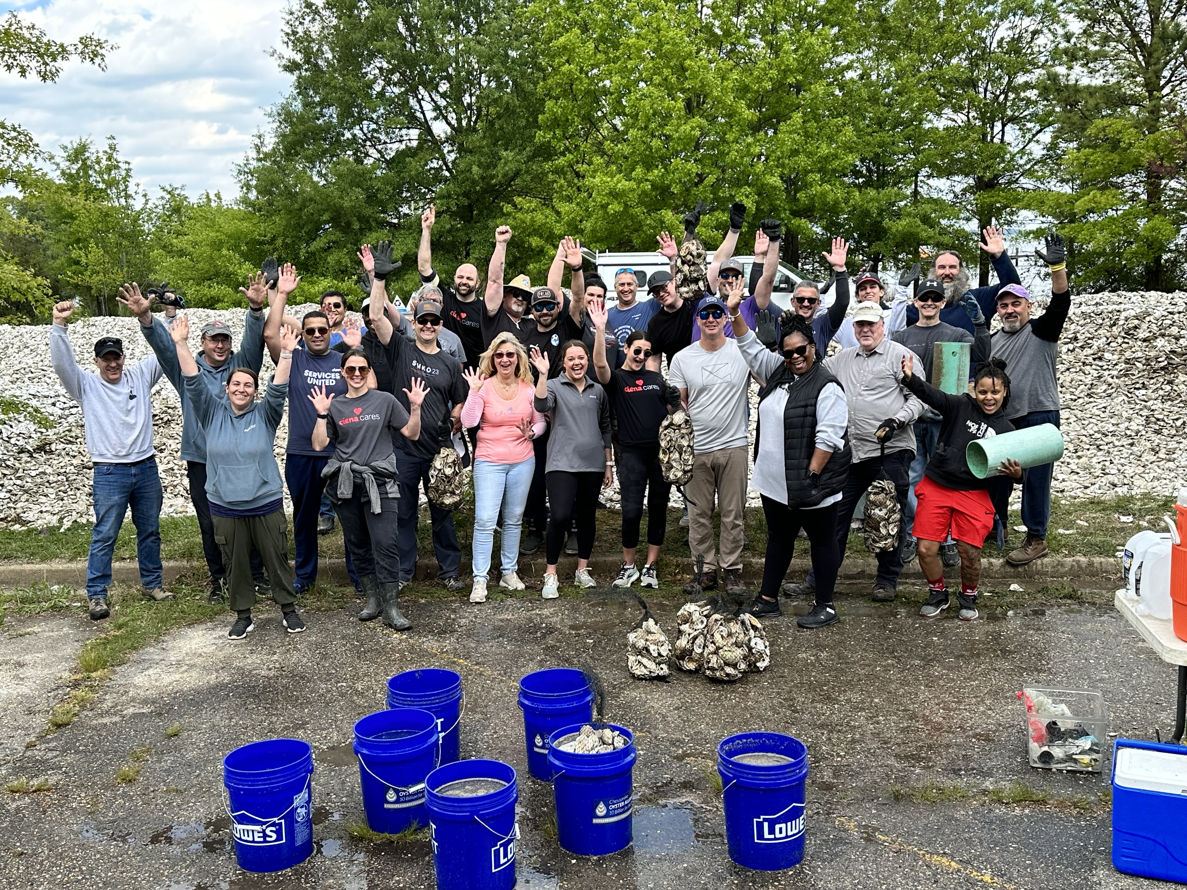 Men and women smiling with their hands in the air 