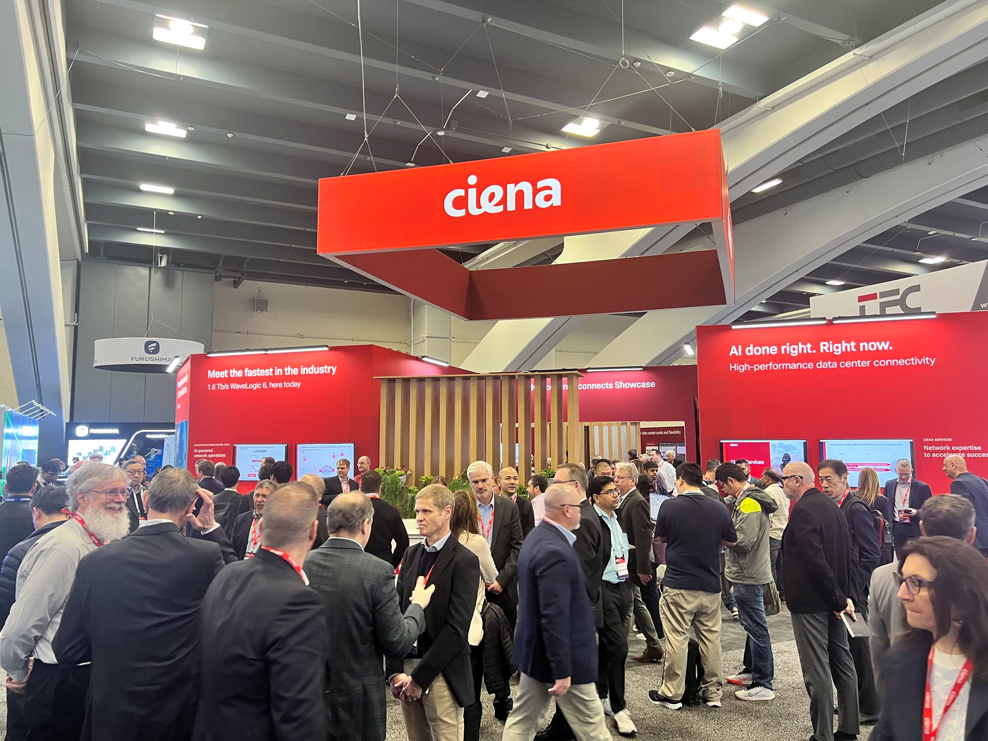 people at and around Ciena's booth at OFC