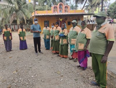 Man standing outside with Indian security workers