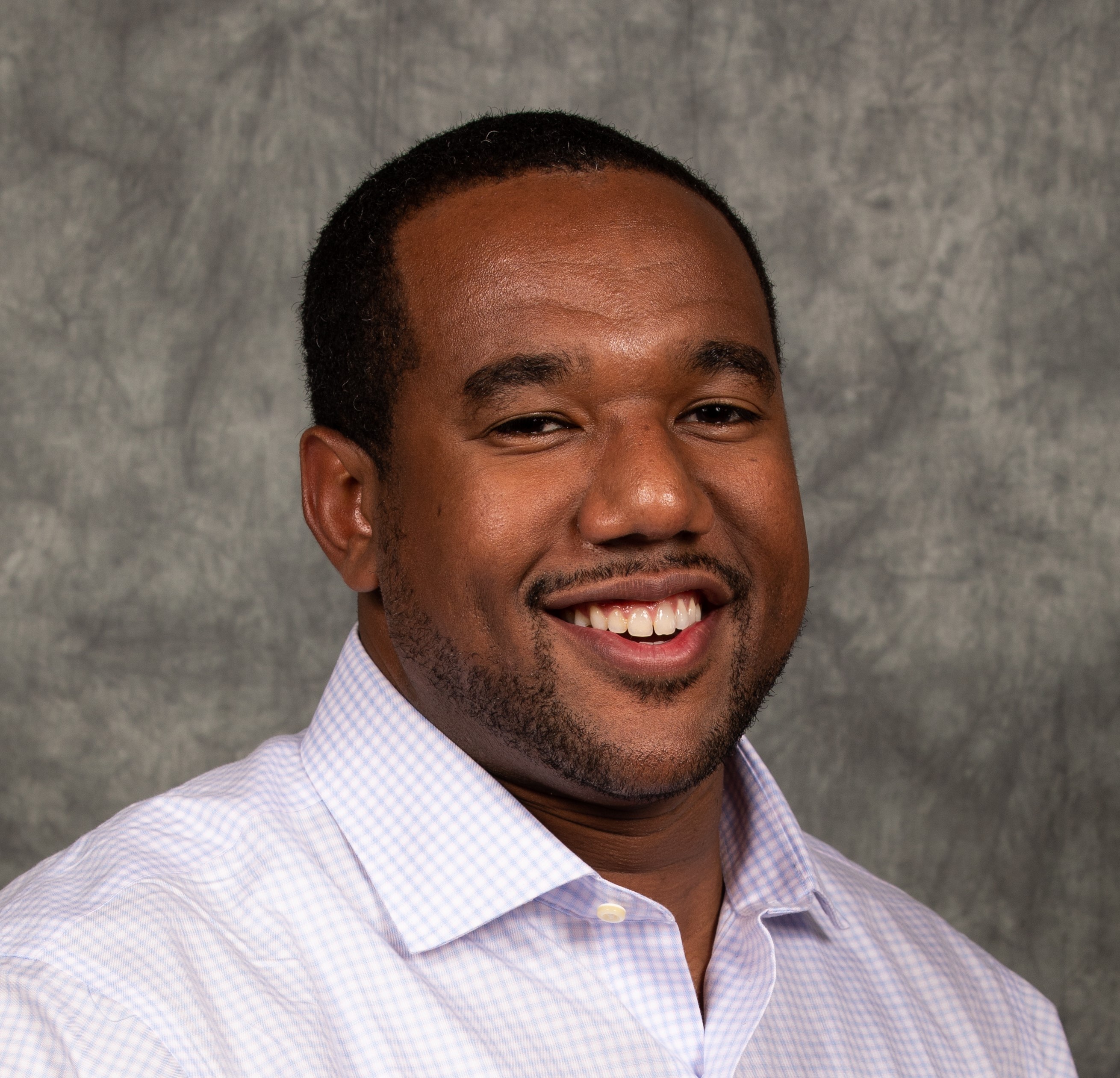 headshot image of man smiling 