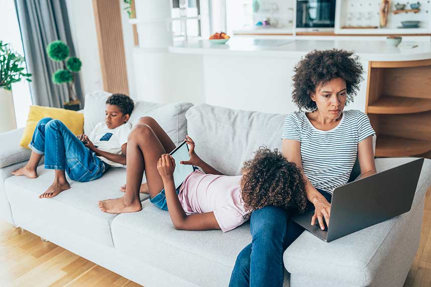 A family in the living room using their devices