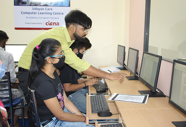 Three people looking at three computer screens