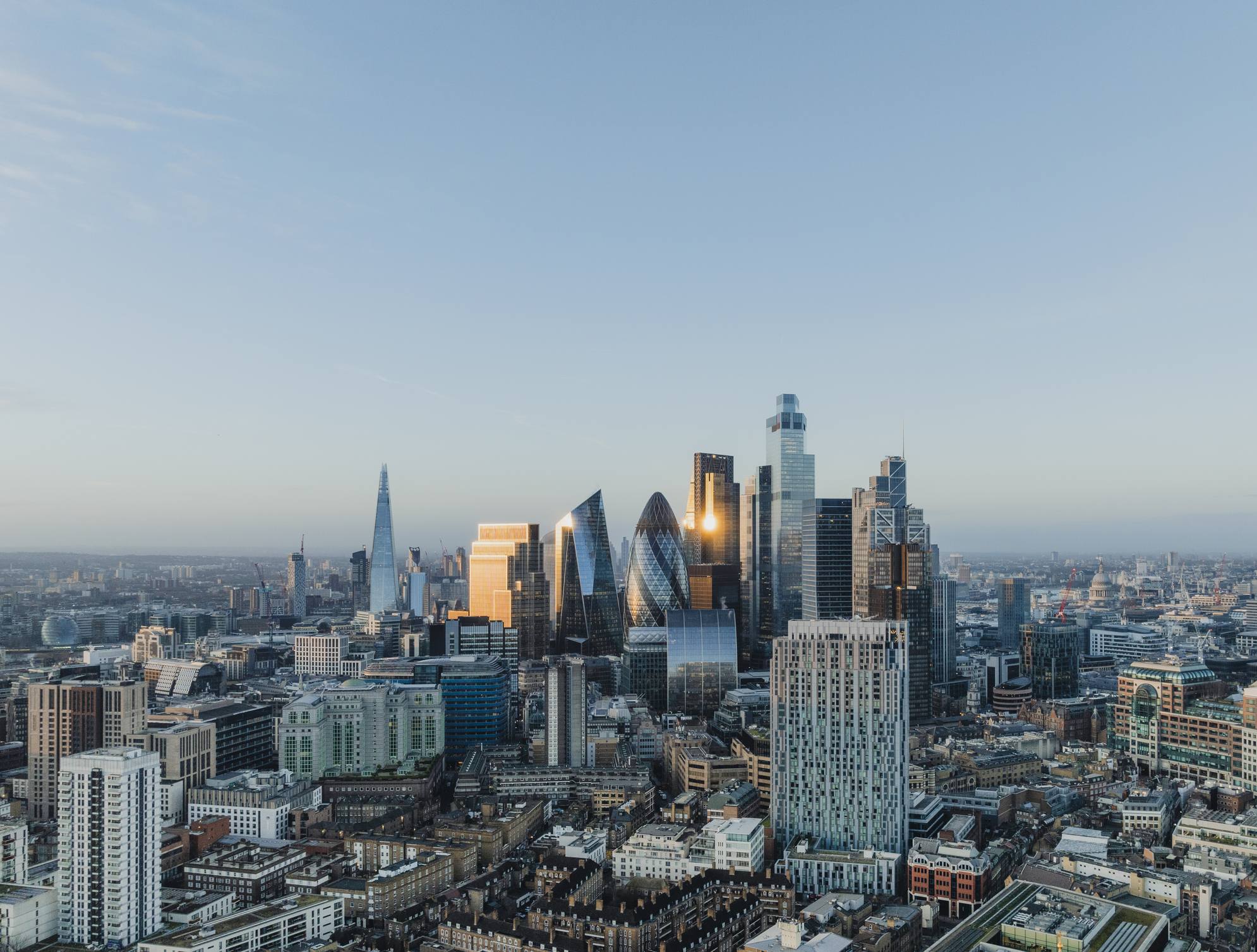 London skyline featuring The Shard, the City of London skyscrapers, and surrounding urban development.